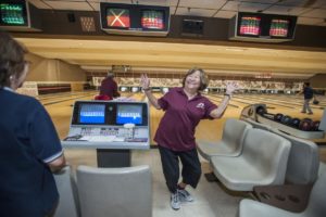 Pauline Fujino, 79, of Santa Ana, a member of the Nikkei Seniors bowling group, does a little dance following her strike early one morning at the Linbrook Bowling Center in Anaheim. MARK RIGHTMIRE, THE OC REGISTER
